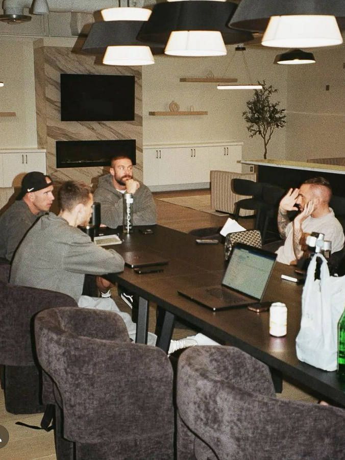 Men gathered around a table in real conversation